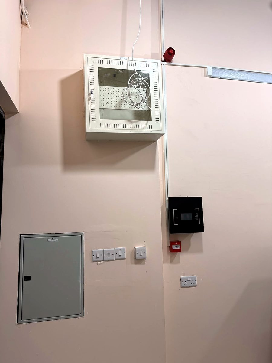 Access control reader and network cabinet installed on an office wall