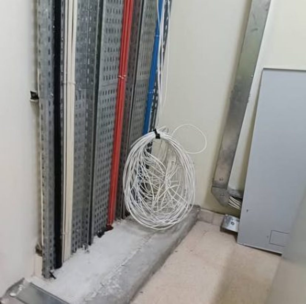 Cable trays and a coiled network cable ready for termination