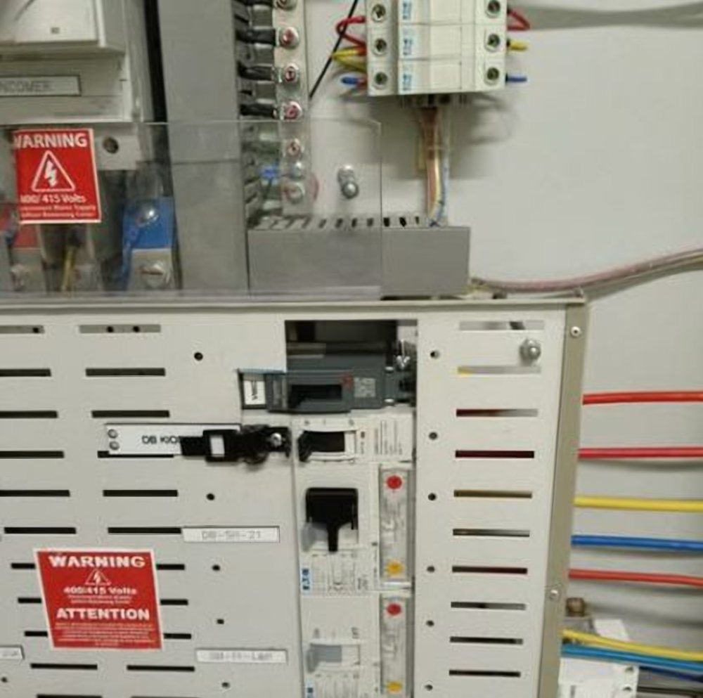 Electrical distribution board with warning labels