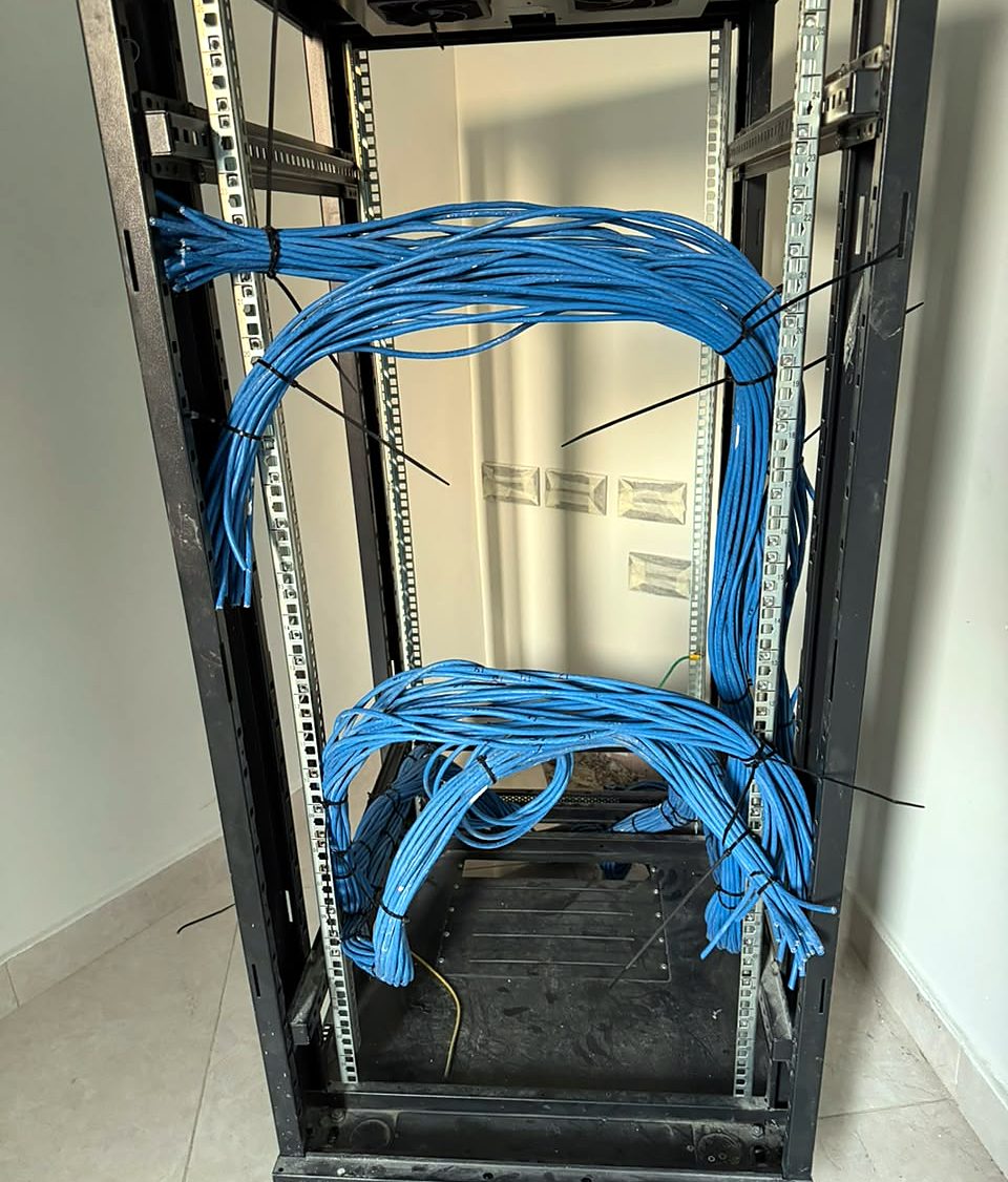 Network cables bundled and dressed inside a server rack by Mizan