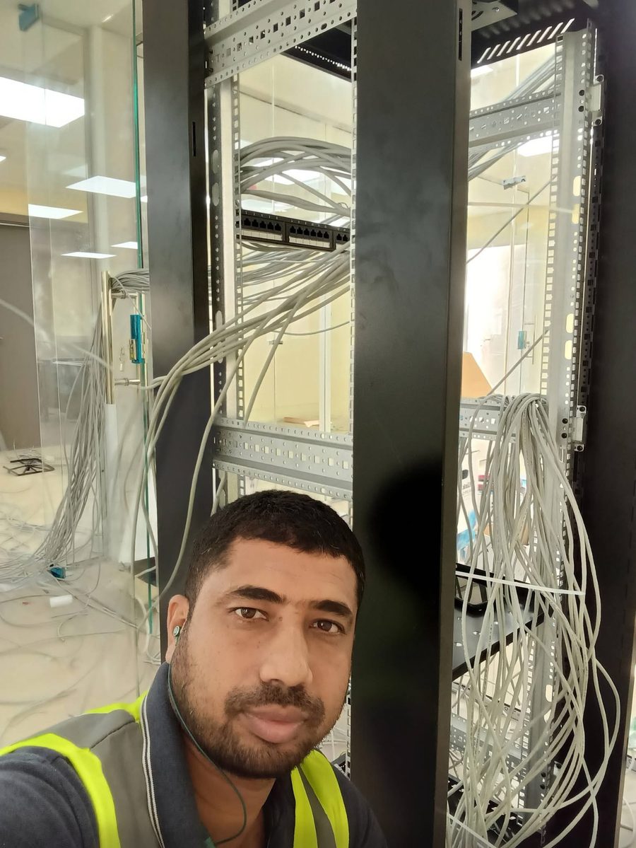 Mohammad Mizanur Rahman of MTM Group Tech working on a network rack in Dubai
